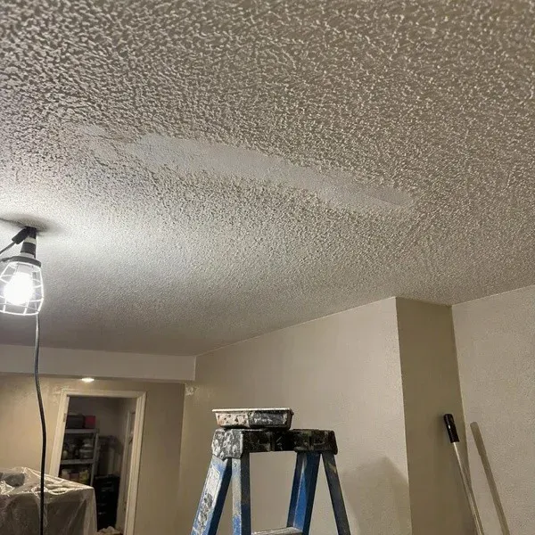 Small ceiling crack repaired beneath matching ceiling texture