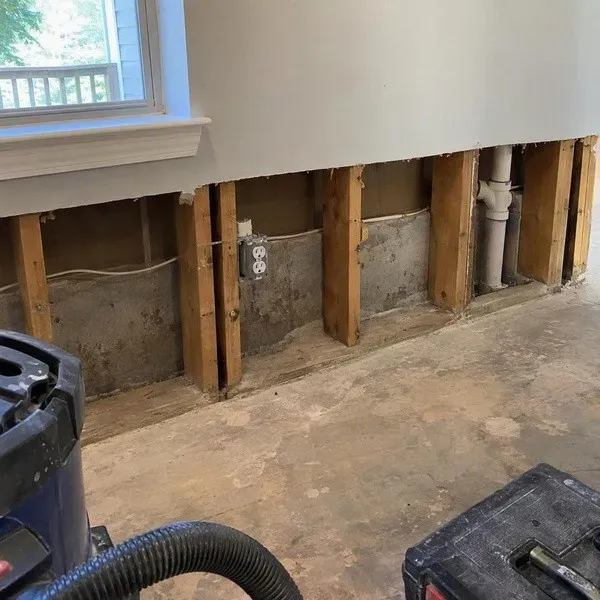 Flood-cut drywall removed to expose wall studs after water damage