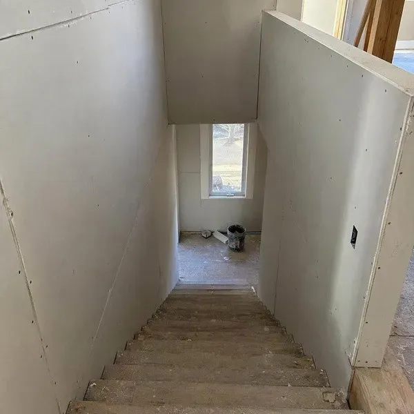 Stairwell walls covered in freshly installed drywall