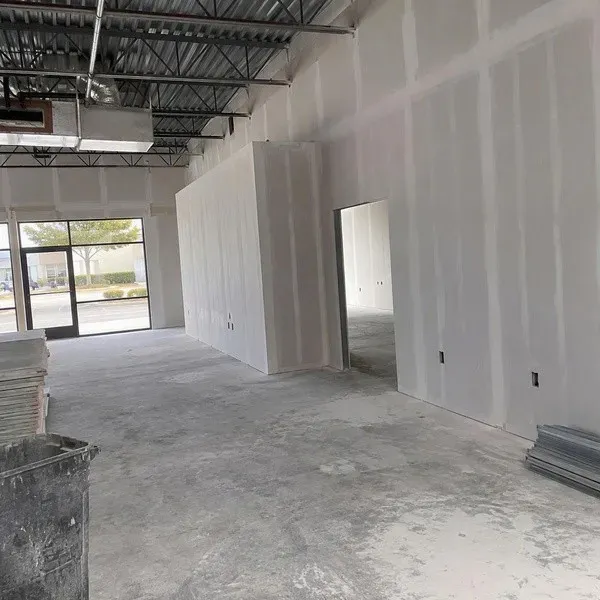 Completed drywall partitions in an empty storefront tenant finish